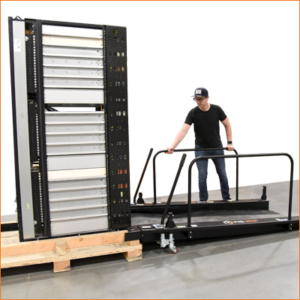 A user maneuvering the ramp flush with the server rack pallet